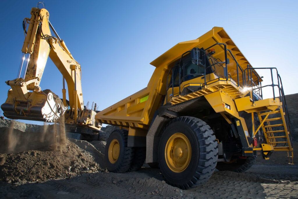 Heavy equipment, Dump Truck and Excavator during a mining operation.